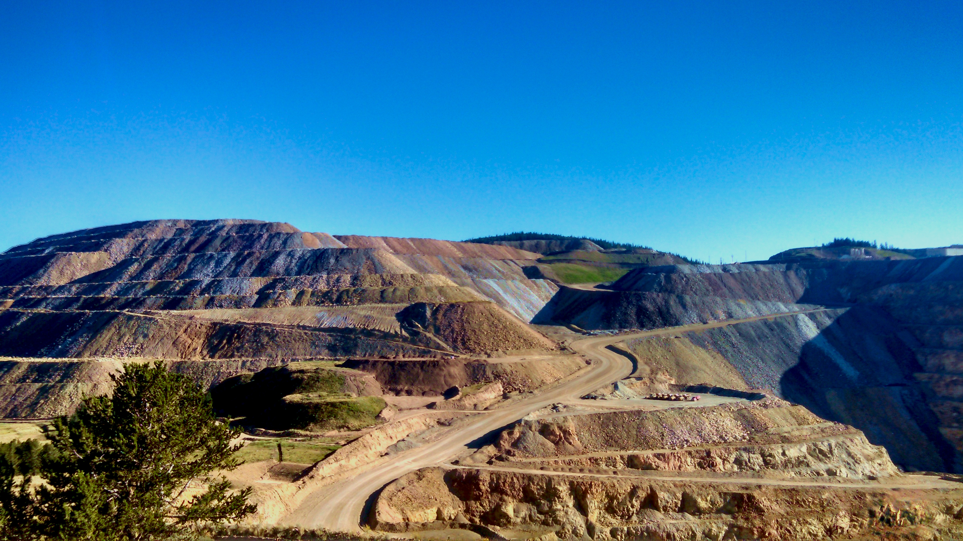 A tiered hill with a winding road winding up it