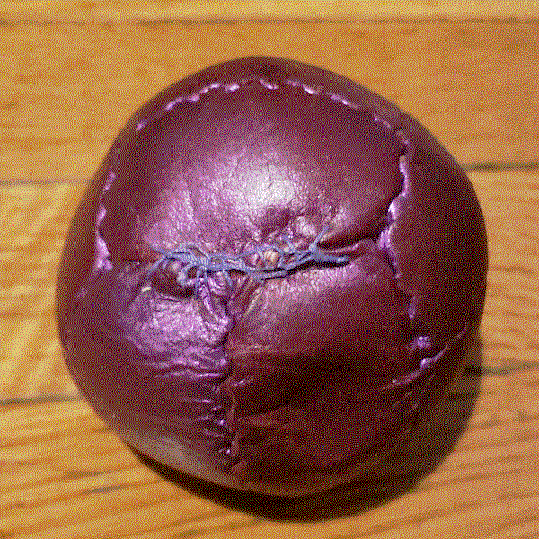 Picture of the same ball with a haphazard looking fix in with a slightly different color of purple thread