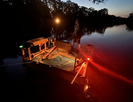 Nighttime picture of the boat showing the light system, with some large lens flares