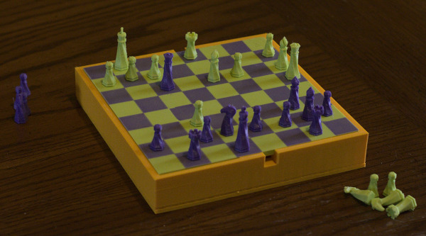 A picture of the chess board in the middle of a two player game, with green playing against purple