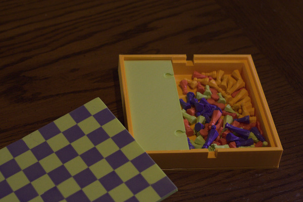 The board with the top off, showing all the pieces inside